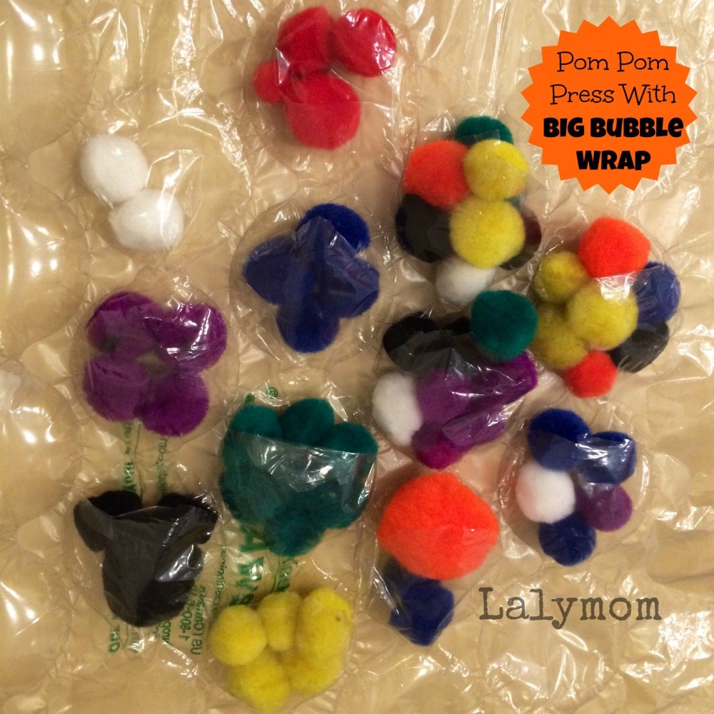 Fine Motor Activity Using Pom Poms and Big Bubble Wrap from Lalymom