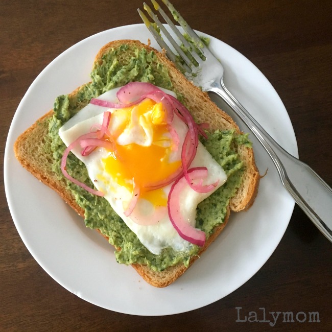 Breakfast Made with Sun Basket Snacks And Leftovers - Multigrain toast with Spinach Artichoke Spread, Over Easy Egg and Pickled Onion