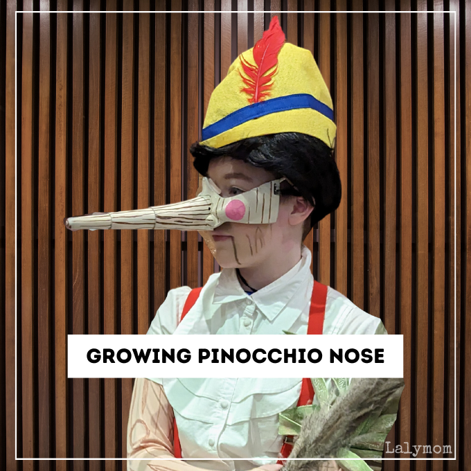 Photo of an actor dressed as pinocchio. text overlay reads Growing Pinocchio Nose